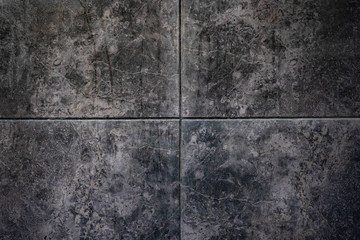 Natural stone texture abstract background. Dark stone surface texture. Grey, black and brown rectangle tiles. Interior panel. Close up, copy space