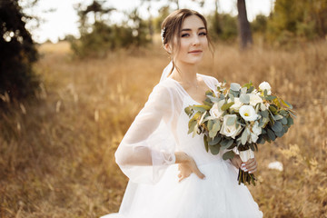 Attractive bride in the autumn forest 