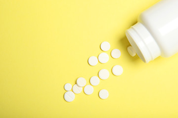 pills on a colored background top view. Medicine, treatment, illness. Medication in tablets.