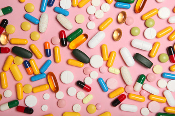 pills on a colored background top view. Medicine, treatment, illness. Medication in tablets.