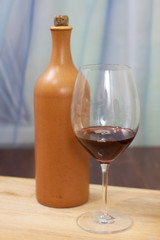 a bottle of homemade wine with two glasses on the table