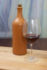 a bottle of homemade wine with two glasses on the table