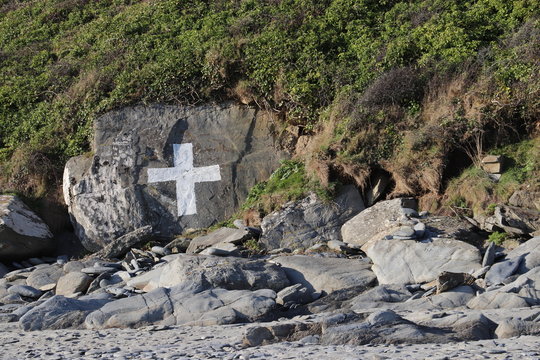 White cross painted on rock 