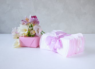 women's hygiene products in problem days and a box with spring flowers on a light background, the concept of women's health