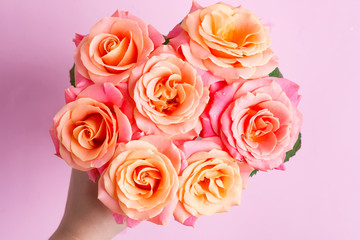 Close up blooming background from fresh natural roses flowers with droplets of water on the petals. Top view.