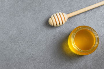 tasty honey in a jar with copy space, top view