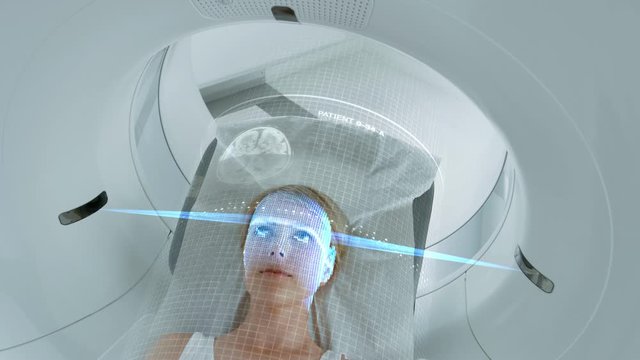 Female Patient Lying on a CT or PET or MRI Scan Bed, Moving Inside the Machine While it Scans Her Brain and Vital Parameters