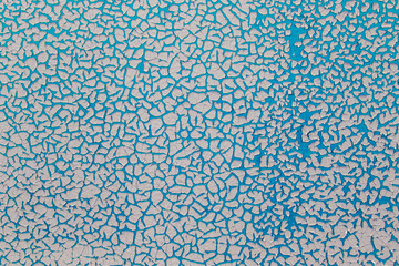 Old paint background. Texture and pattern of peeling dried old paint on the wall. Old painted wall background