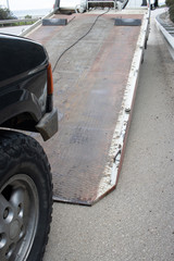 Loading broken car on a tow truck on a roadside