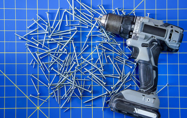 Powerdrill with Screws on Blue Stationary Mat