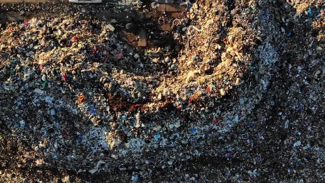 Landfill site, top view. Heap of garbage. Theme of ecology and pollution, conservation of clean environment and nature. Drone overhead view, zoom out