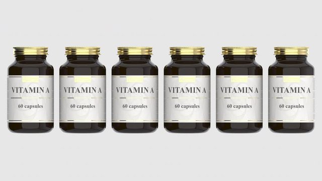 Glass bottles with generic vitamin A capsules and fictional logo. Pharmaceutical industrial production related 3D animation