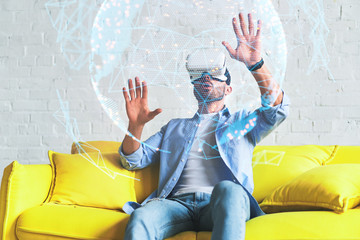 Portrait of amazed excited man watching virtual reality glasses, touching hologram