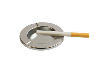 Cigarette in an ashtray on a white background