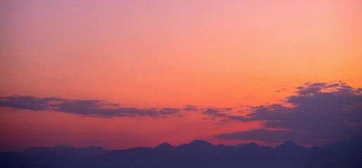 Obraz na płótnie Canvas Orange sky over silhouette mountain in the morning.