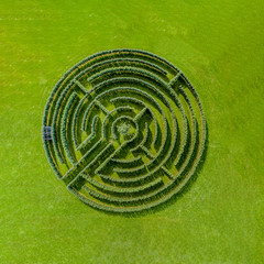 Aerial view of round circular maze made of trees and bush	
