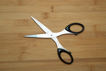Office scissors on a wooden background. Stationery.