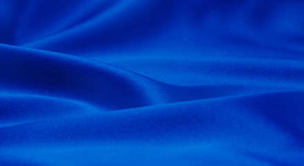 Obraz premium Blue satin or silk fabric as background