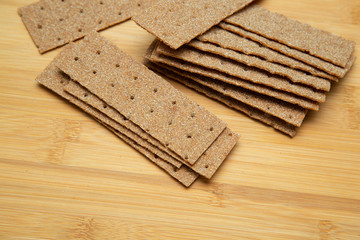 Crunchy bread on a wooden background. Good nutrition.