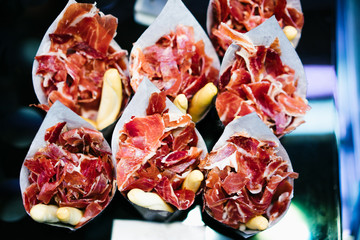 slice spanish hamon in barcelona market, jamon iberico isolated, traditional national spain meat in...