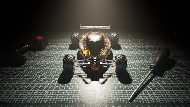 Radio controlled racing car with flame decals on a cutting mat