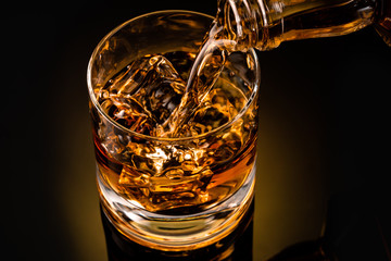 glass of whiskey on black background