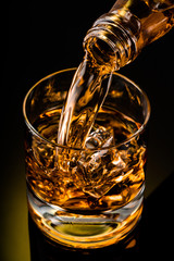 glass of whiskey on black background