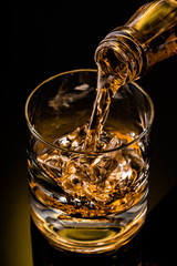 glass of whiskey on black background	