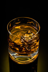 glass of whiskey on black background	