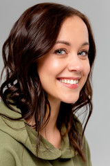 Naklejka premium beauty woman portrait of teen girl beautiful cheerful enjoying with long brown hair and clean skin isolated on gray background