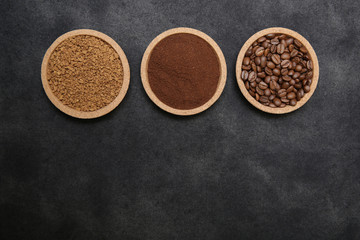 Coffee various - roasted beans or grain and ground and instant coffee on black fabric background. The sequence of preparation of the drink. Coffee concept. Flat lay. Top view. Copy space for text.