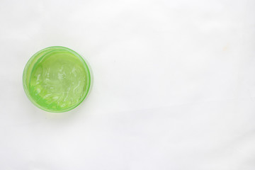 Jar of cream and flowers on white background, top view. Professional cosmetic products