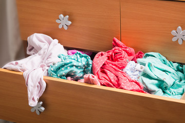 Mess in children clothes in drawer. Soft focus