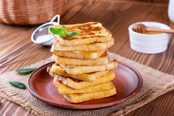 Traditional sweet fried toasts with honey and mint