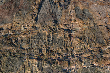 natural surface of brown stone with white stripes, rock texture