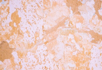 Background of cracked clay wall covered with lime and paint.