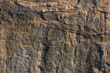 natural surface of brown stone with black and white spots, rock texture