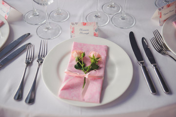 Banquet service with pink napkins, glasses, pink bouquets. Different meals for breakfast or lunch time. Wedding evening