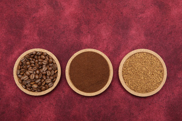 Coffee various - roasted beans or grain and ground and instant coffee on red fabric background. The sequence of preparation of the drink. Coffee concept. Flat lay. Top view. Copy space for text.