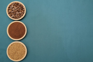 Coffee various - roasted beans or grain and ground and instant coffee on aqua ment or turquoise fabric background. The sequence of preparation of the drink Coffee concept. Flat lay Top view Copy space