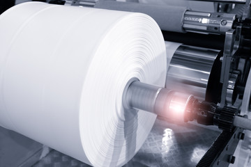 The operation of automatic plastic bag production machine. Close-up of the roller of the...