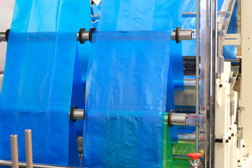 The operation of automatic plastic bag production machine. Close-up of the roller of the...