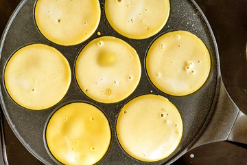 pancake frying pan with smile face pancake cooking on cooker in kitchen