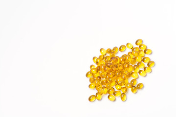 Many transparent tablet of yellow color on a white background. View from above