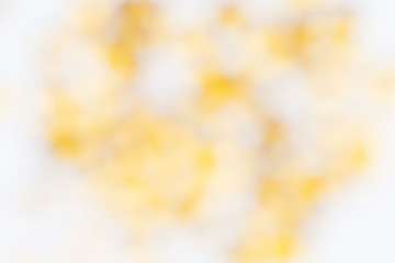 Abstract white background with blurred yellow spots