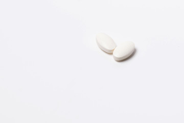 Fototapeta na wymiar Two white tablet oval shaped on a white background