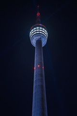 Extreme perspective of Stuttgart Television Tower (Fernsehturm) against night sky with stars and light beams, Germany © Timo Günthner