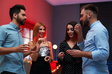 Young people drinking Mexican Tequila shots in bar