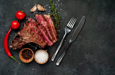 Grilled beef steak with spices on a stone background with copy space for your text.