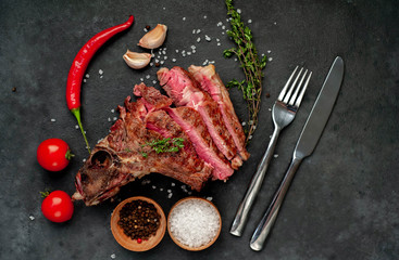 Grilled beef steak with spices on a stone background with copy space for your text.